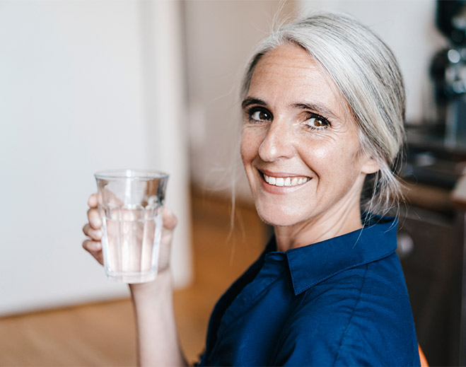 Woman Holding Glass of Water